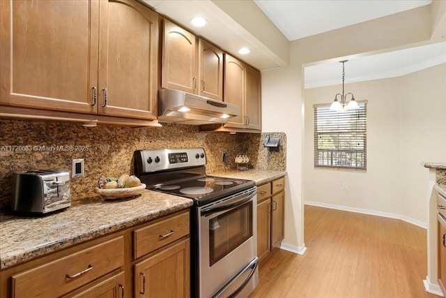 kitchen featuring light stone countertops, tasteful backsplash, light hardwood / wood-style flooring, a chandelier, and stainless steel electric range