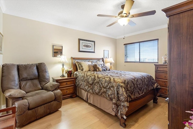 bedroom with a textured ceiling, ceiling fan, light hardwood / wood-style floors, and crown molding