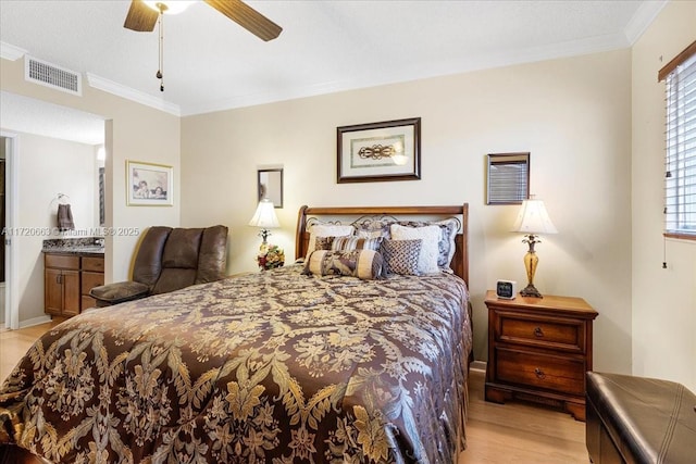 bedroom featuring light hardwood / wood-style flooring, ceiling fan, ornamental molding, a textured ceiling, and connected bathroom