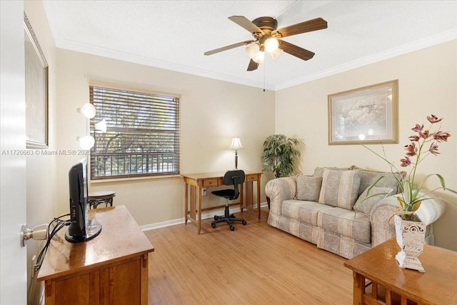 office space featuring light wood-type flooring, ceiling fan, and crown molding