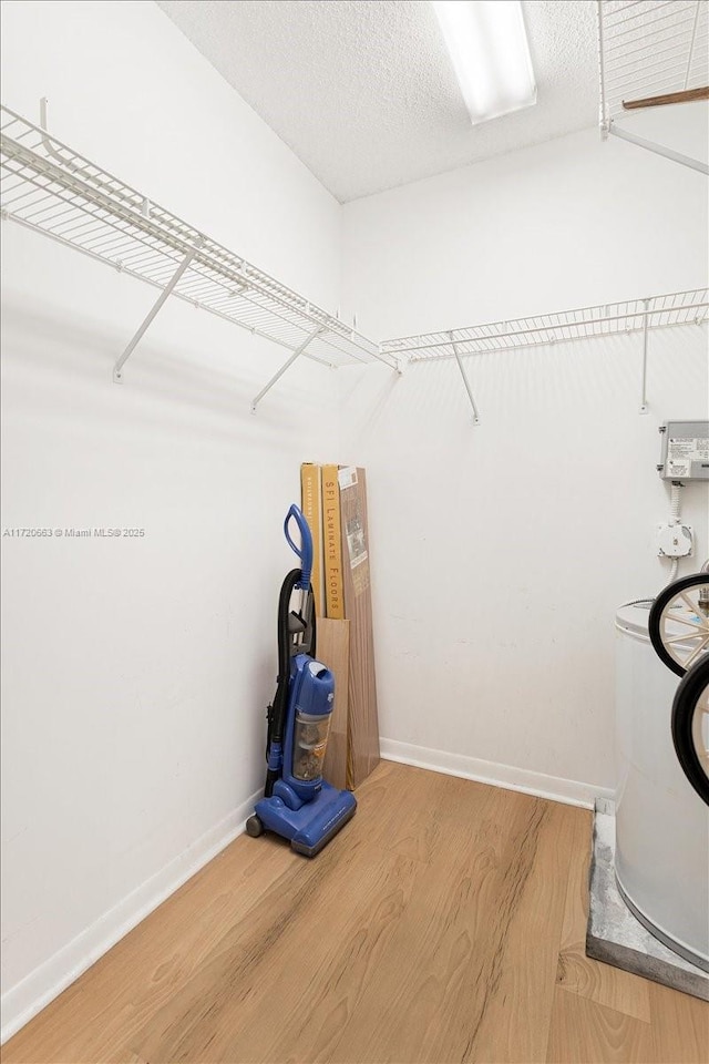 spacious closet with hardwood / wood-style floors and washer / dryer