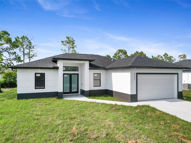 view of front of house with a front yard and a garage