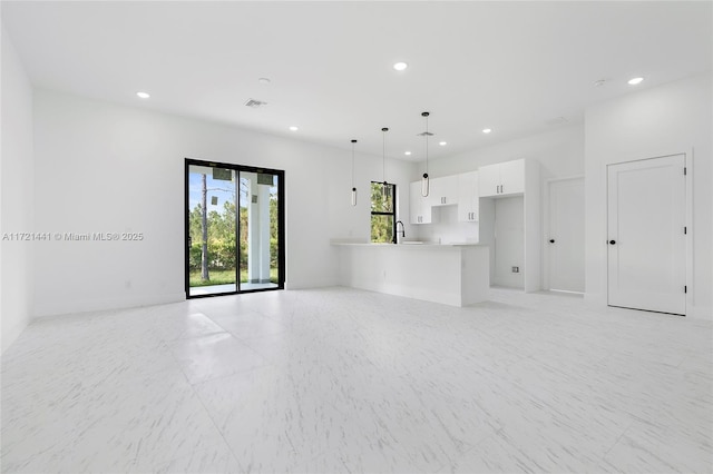 unfurnished living room with sink