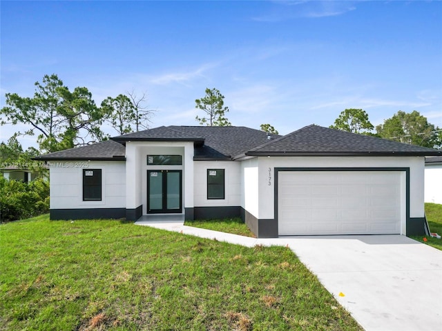 view of front of home with a garage and a front lawn