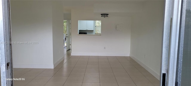 hall featuring light tile patterned flooring