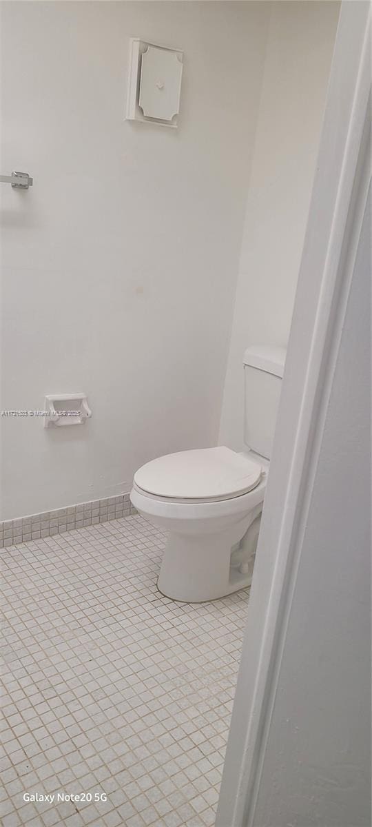 bathroom with tile patterned flooring and toilet