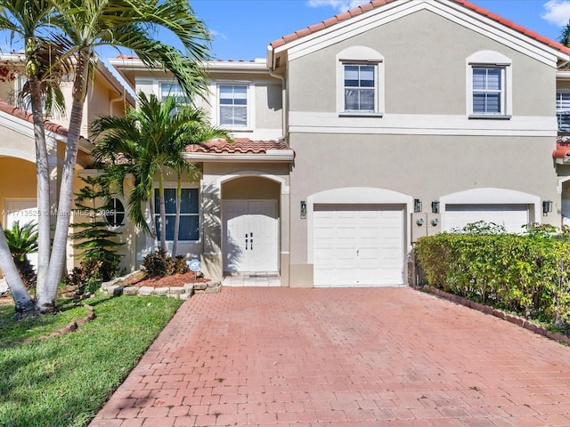 mediterranean / spanish-style house with a garage