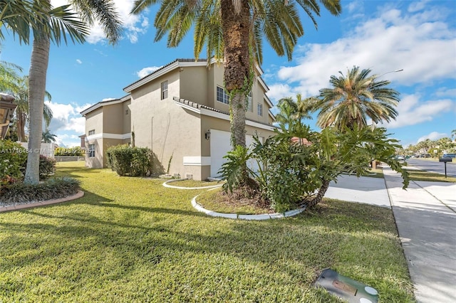 view of side of property with a garage and a yard