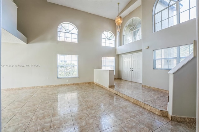 entryway featuring a high ceiling and a notable chandelier