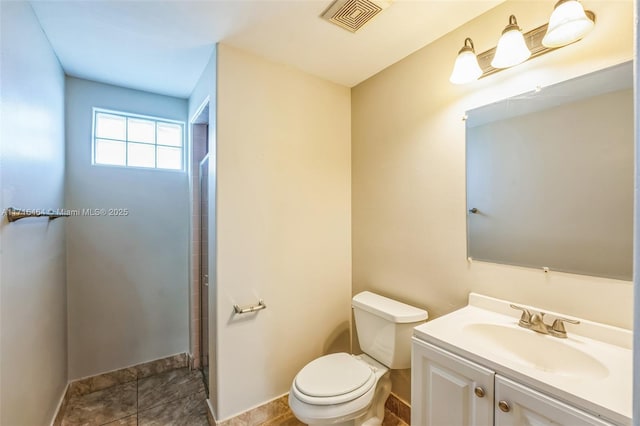 bathroom with toilet and vanity