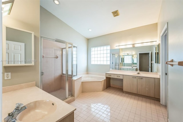 bathroom with vaulted ceiling, vanity, tile patterned floors, and independent shower and bath