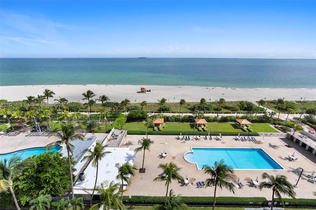 drone / aerial view with a water view and a view of the beach