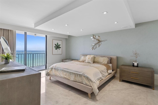 bedroom with access to outside and a water view