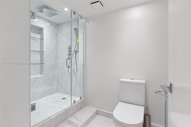 bathroom featuring tile patterned flooring, an enclosed shower, and toilet