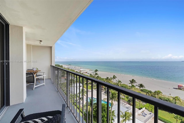 balcony featuring a beach view and a water view