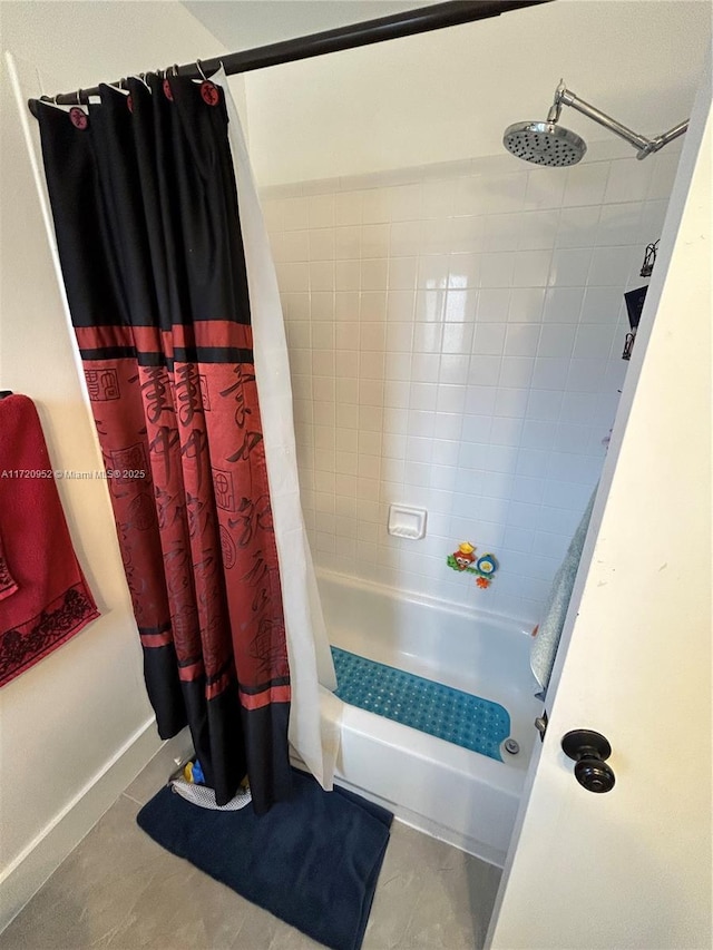 bathroom with tile patterned floors and shower / tub combo