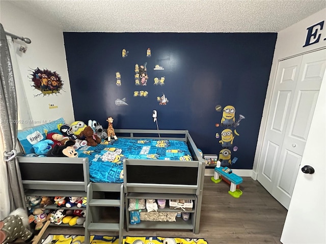 bedroom featuring hardwood / wood-style floors and a textured ceiling