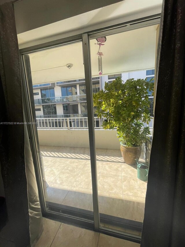 doorway to outside with tile patterned flooring