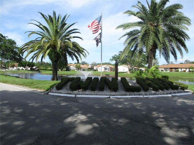 view of property's community featuring a water view and a yard