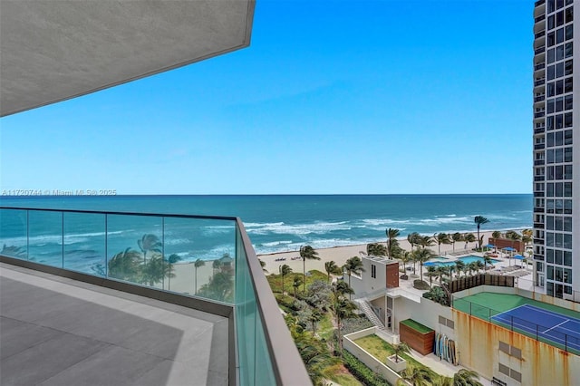 balcony featuring a water view and a beach view