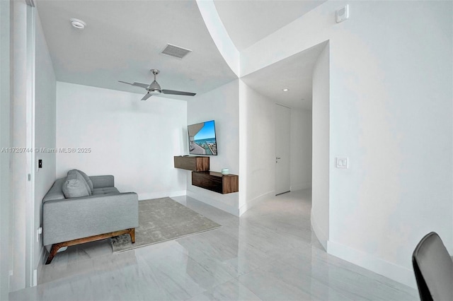 living area with ceiling fan