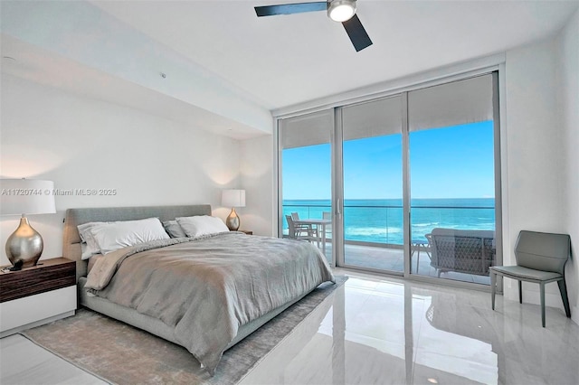 bedroom featuring access to exterior, ceiling fan, a water view, and a wall of windows