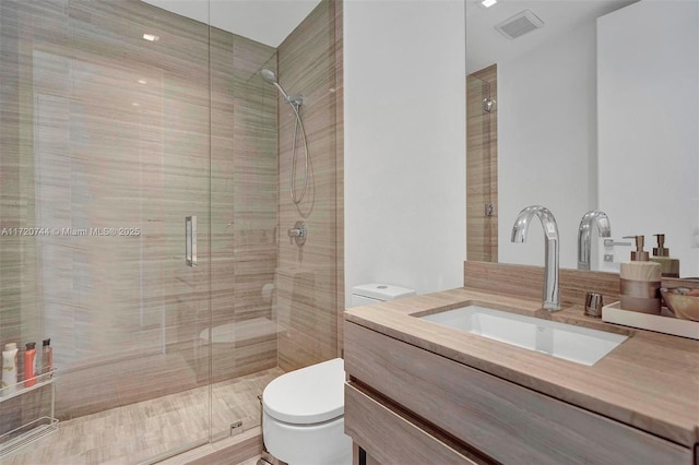 bathroom featuring vanity, toilet, and walk in shower