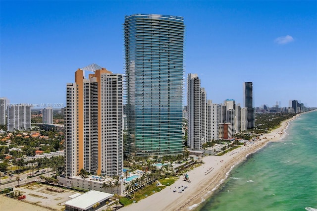 view of city featuring a water view and a beach view