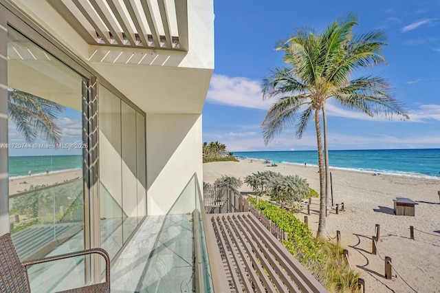 balcony with a view of the beach and a water view