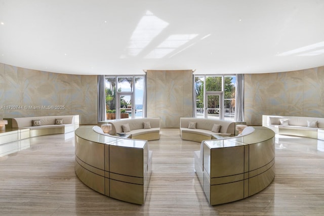 living room with a wealth of natural light and a wall of windows