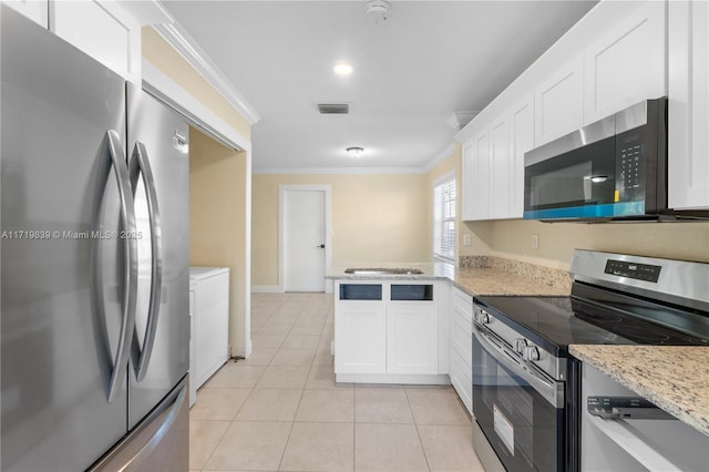 kitchen with appliances with stainless steel finishes, light stone counters, crown molding, light tile patterned floors, and white cabinets