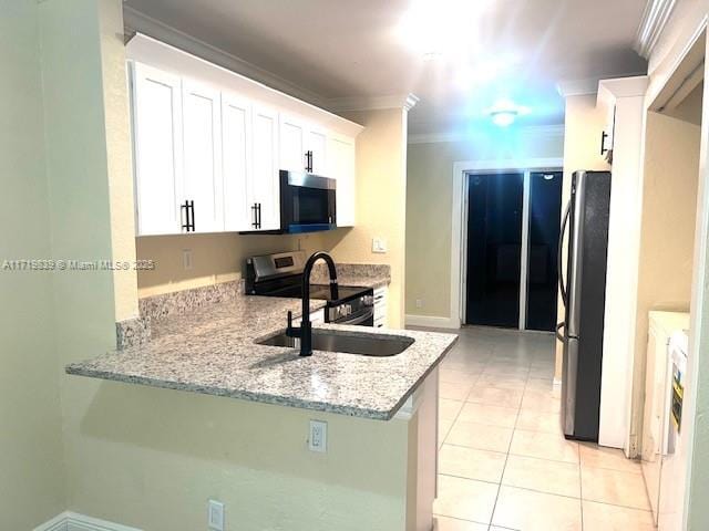 1574 NW 7th Ln, Pompano Beach, FL 33060 - kitchen with appliances with stainless steel finishes, crown molding, light stone countertops, white cabinets, and light tile patterned flooring