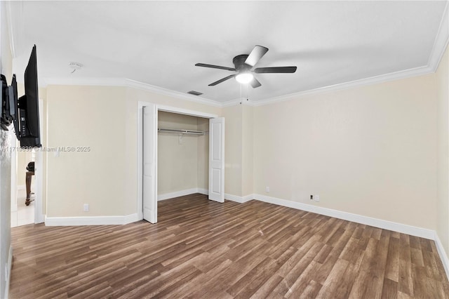 unfurnished bedroom with hardwood / wood-style floors, a closet, ceiling fan, and ornamental molding