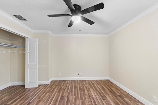 unfurnished bedroom with ceiling fan, wood-type flooring, ornamental molding, and a closet