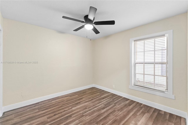 spare room featuring ceiling fan, a healthy amount of sunlight, and wood-type flooring