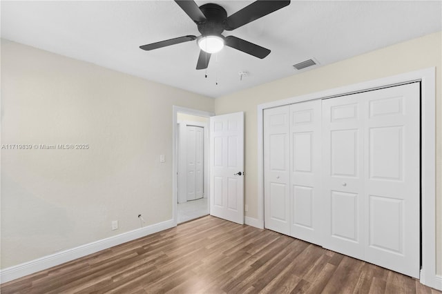 unfurnished bedroom featuring a closet, ceiling fan, and hardwood / wood-style flooring