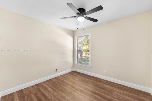 spare room with hardwood / wood-style flooring and ceiling fan