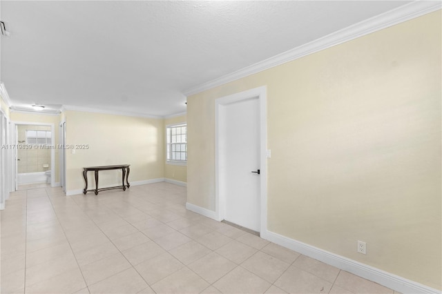 tiled spare room featuring crown molding