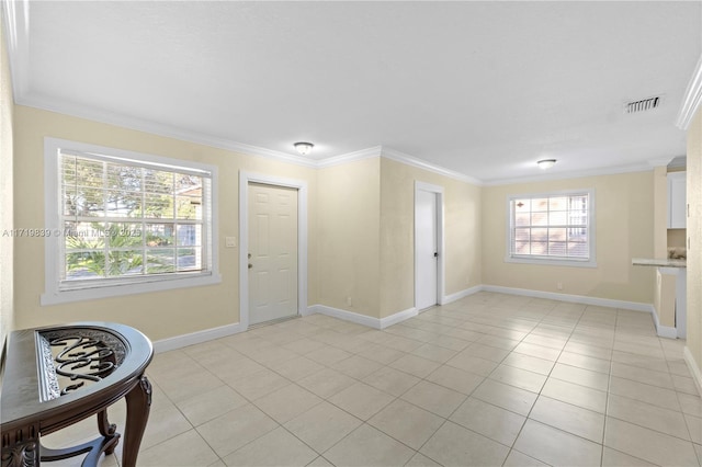 interior space with light tile patterned flooring and ornamental molding