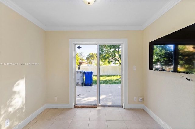 entryway with light tile patterned floors and crown molding