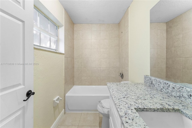 bathroom featuring tile patterned flooring, vanity, a textured ceiling, and toilet