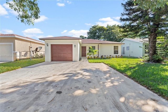 single story home with a garage and a front lawn