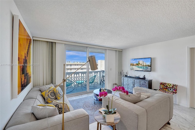 living room with expansive windows and a textured ceiling