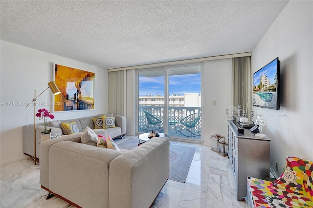 living room featuring a wall of windows and a textured ceiling