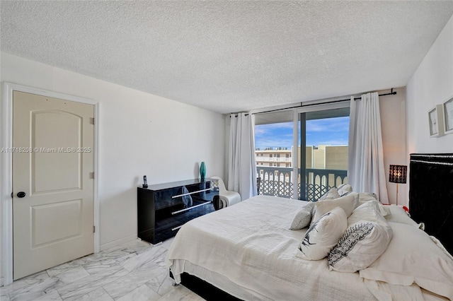 bedroom with access to exterior, floor to ceiling windows, and a textured ceiling