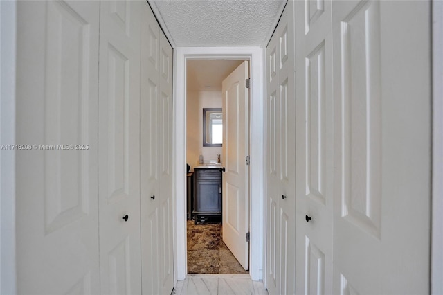 corridor with a textured ceiling