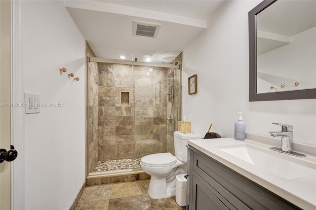 bathroom with vanity, toilet, and an enclosed shower