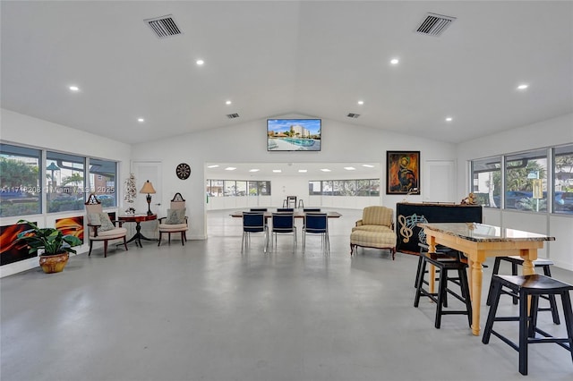 dining space with concrete floors and lofted ceiling