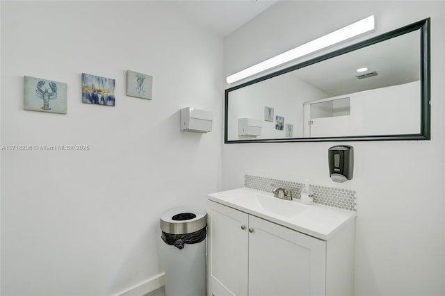 bathroom featuring vanity and tasteful backsplash