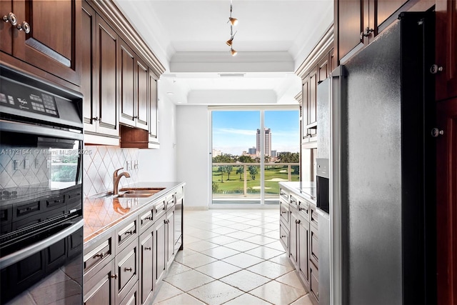 kitchen with stainless steel fridge with ice dispenser, sink, light tile patterned floors, and tasteful backsplash